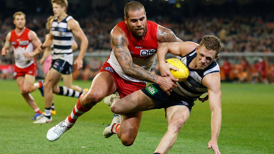 Buddy Franklin tackles Joel Selwood.