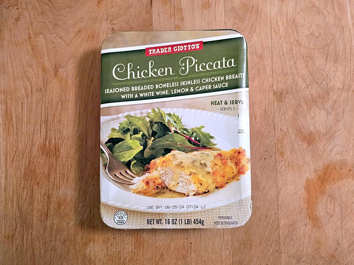 A box of Trader Joe's chicken piccata against a wooden background.