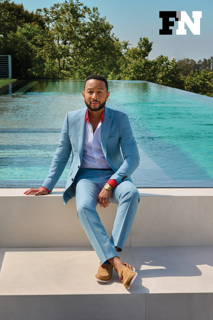 John Legend wears a Burberry suit, Gucci shirt and Sperry shoes exclusively for his Footwear News cover shoot, June 2021. - Credit: Yu Tsai