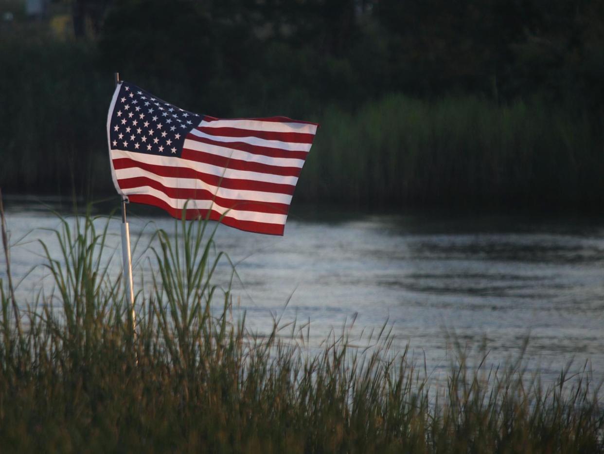 Tim Wilson, of Leland, placed an American Flag in the Brunswick River several years ago. Since then the flag has been replaced several times by Wilson and other times it has been replaced anonymously.