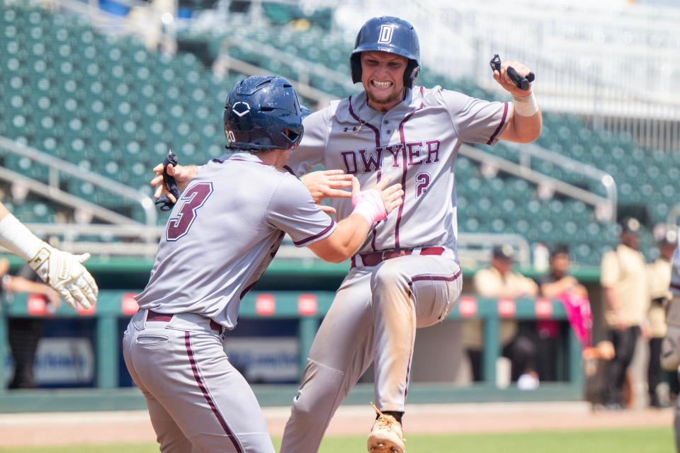 Dwyer Panthers Bryce Jackson (2) jumps on home plate to score a run along with Jackson Miller (3) during their game with the Buchholz Bobcats in class 6A Championship high school baseball match up on Saturday, May 18, 2024, in Fort Myers, Fla. (Photo/Chris Tilley)