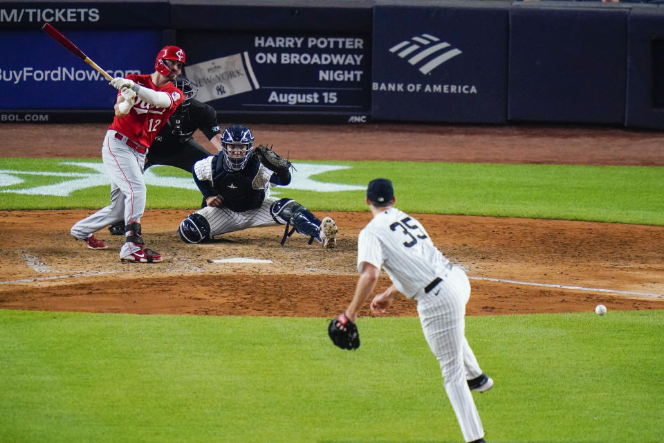 Cincinnati Reds' Tyler Naquin watches an RBI single past New York Yankees relief pitcher Clay Holmes (35) during the ninth inning of a baseball game Tuesday, July 12, 2022, in New York. (AP Photo/Frank Franklin II)