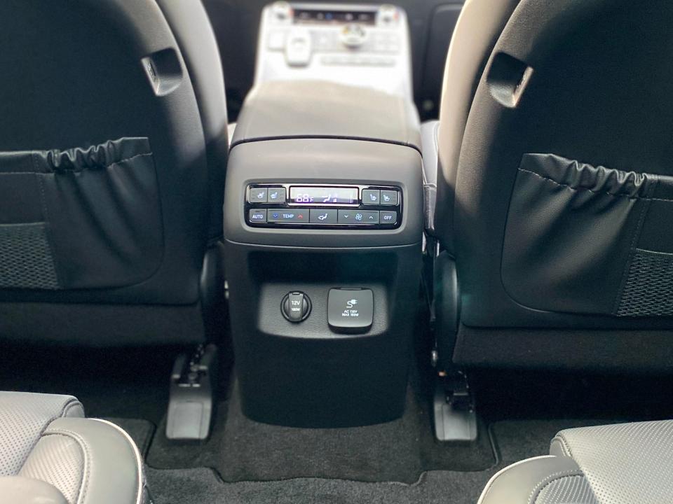 The rear cabin climate controls and charging plugs on a Hyundai Palisade SUV.