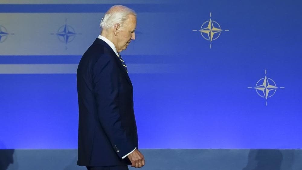 US President Joe Biden takes the stage for a family photo during the NATO 75th Anniversary ceremony