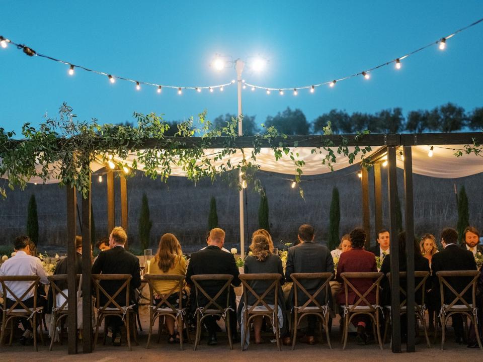 A tent with wedding guests.