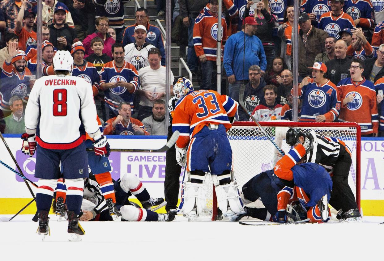 Washington Capitals' Alex Ovechkin (8) looks on as Edmonton Oilers' goalie Cam Talbot (33) and other players get into a scrum during the second period of an NHL hockey game in Edmonton, Alberta, Wednesday, Oct. 26, 2016. (Jason Franson/The Canadian Press via AP)