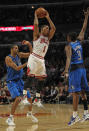 CHICAGO, IL - APRIL 21: Derrick Rose #1 of the Chicago Bulls leaps to pass between Brandon Wright #34 and Rodrigue Beaubois #3 of the Dallas Mavericks at the United Center on April 21, 2012 in Chicago, Illinois. The Bulls defeated the Mavericks 93-83. NOTE TO USER: User expressly acknowledges and agress that, by downloading and/or using this photograph, User is consenting to the terms and conditions of the Getty Images License Agreement. (Photo by Jonathan Daniel/Getty Images)