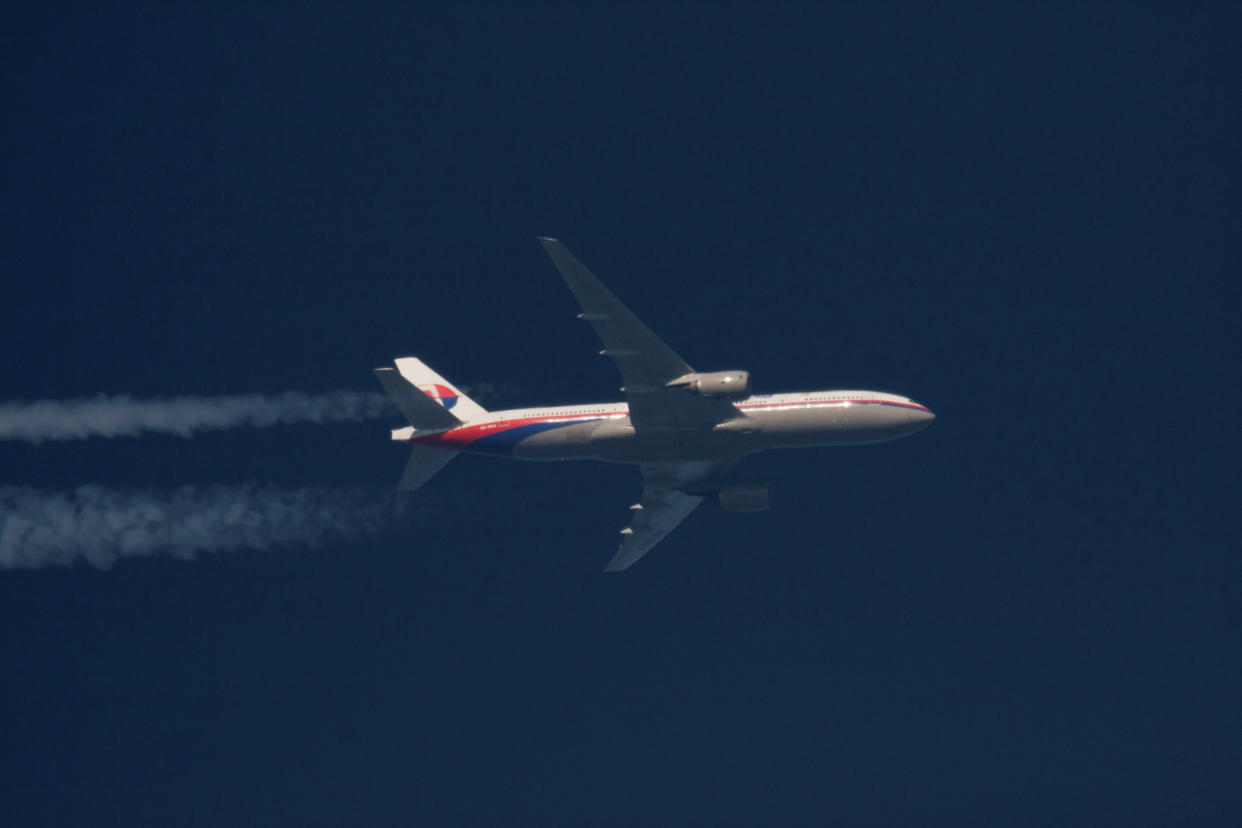 FILE PHOTO: Malaysian Airlines Boeing 777-200ER with the registration number 9M-MRO flies over Poland February 5, 2014. The aircraft flying as MH370 disappeared on March 8, 2014, less than an hour into a flight from Kuala Lumpur to Beijing. REUTERS/Tomasz Bartkowiak/File Photo