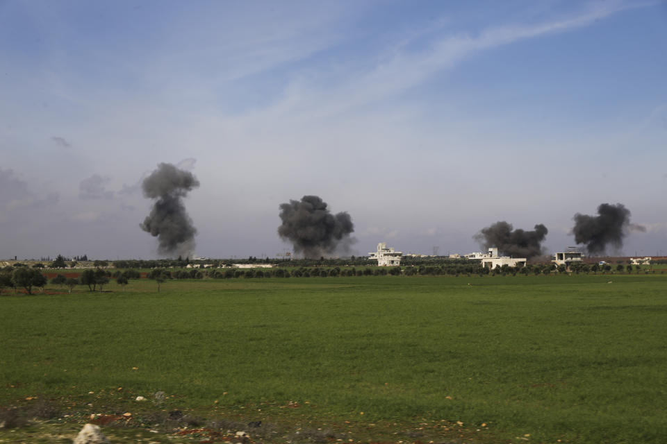 Columns of smoke raise after airstrikes hit town of Saraqeb, in Idlib province, Syria, Thursday, Feb. 27, 2020. Turkey-backed Syrian opposition fighters Thursday retook a strategic northwestern town iof Saraqeb, opposition activists said, and cut off the key highway linking the capital, Damascus, with the northern city of Aleppo, days after the government reopened it for the first time since 2012. (AP Photo/Ghaith Alsayed)