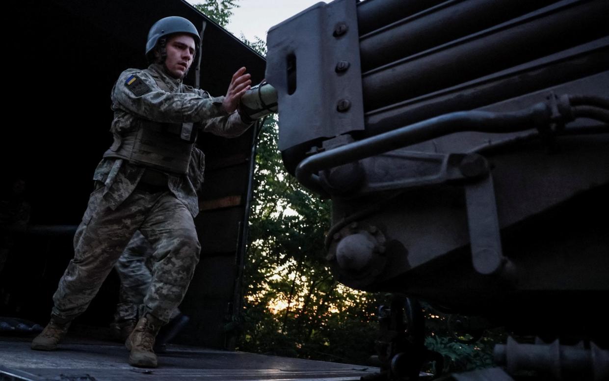 A Ukrainian serviceman of the 110th Colonel-General Marko Bezruchko Separate Mechanized Brigade loads a shell to an RM-70 Vampire multiple launch rocket system