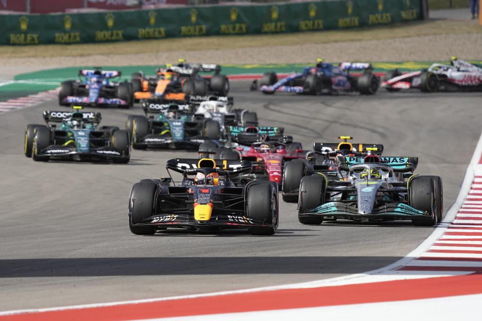 Red Bull driver Max Verstappen, front, of the Netherlands, leads Mercedes driver Lewis Hamilton, right, of Britain, and the rest of the field during the Formula One U.S. Grand Prix auto race at Circuit of the Americas, Sunday, Oct. 23, 2022, in Austin, Texas. (AP Photo/Charlie Neibergall)