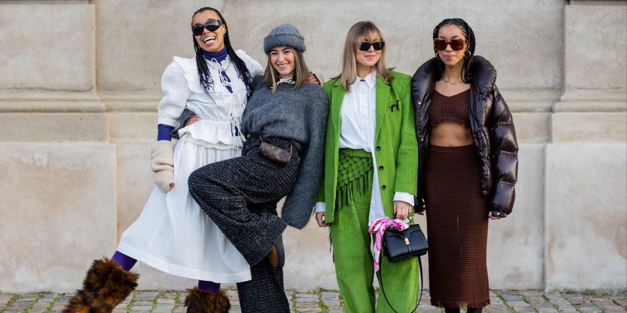 copenhagen, denmark february 02 fia hamelijnck wears white ruffled blouse, skirt, purple leggings, fur boots  benthe liem wears grey jumper, dark black grey wide leg pants, louis vuitton belt bag, cashmere beanie, beige scarf  elise bak wears green corduroy suit, white blouse, black bag  amaka hamelijnck wears brown cropped net top, sheer maxi skirt, brown down feather puffer jacket, sunglasses, boots outside gestuz during the copenhagen fashion week autumnwinter 2023 on february 02, 2023 in copenhagen, denmark photo by christian vieriggetty images