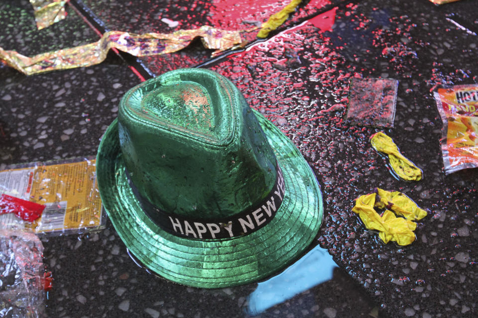 A "Happy New Year" hat lies on the wet ground along with other items following the celebration in New York's Times Square, early Tuesday, Jan. 1, 2019. (AP Photo/Tina Fineberg)