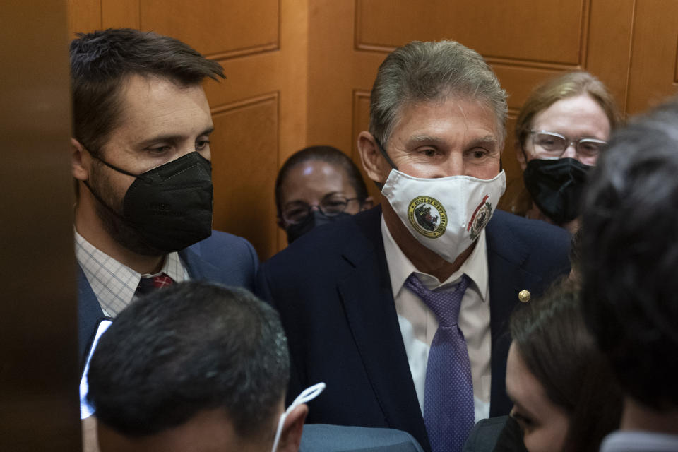 Sen. Joe Manchin, D-W.Va., squeezes into an elevator with White House domestic policy adviser Susan Rice, center, Director of the National Economic Council Brian Deese, left, and other White House officials as they leave a private meeting with Sen. Kyrsten Sinema, D-Ariz., on Capitol Hill in Washington, Thursday, Sept. 30, 2021. Determined not to let his $3.5 trillion government overhaul collapse, President Joe Biden cleared his schedule late Thursday and Speaker Nancy Pelosi pushed the House into an evening session as the Democratic leaders worked to negotiate a scaled-back plan centrist holdouts would accept. (AP Photo/Andrew Harnik)