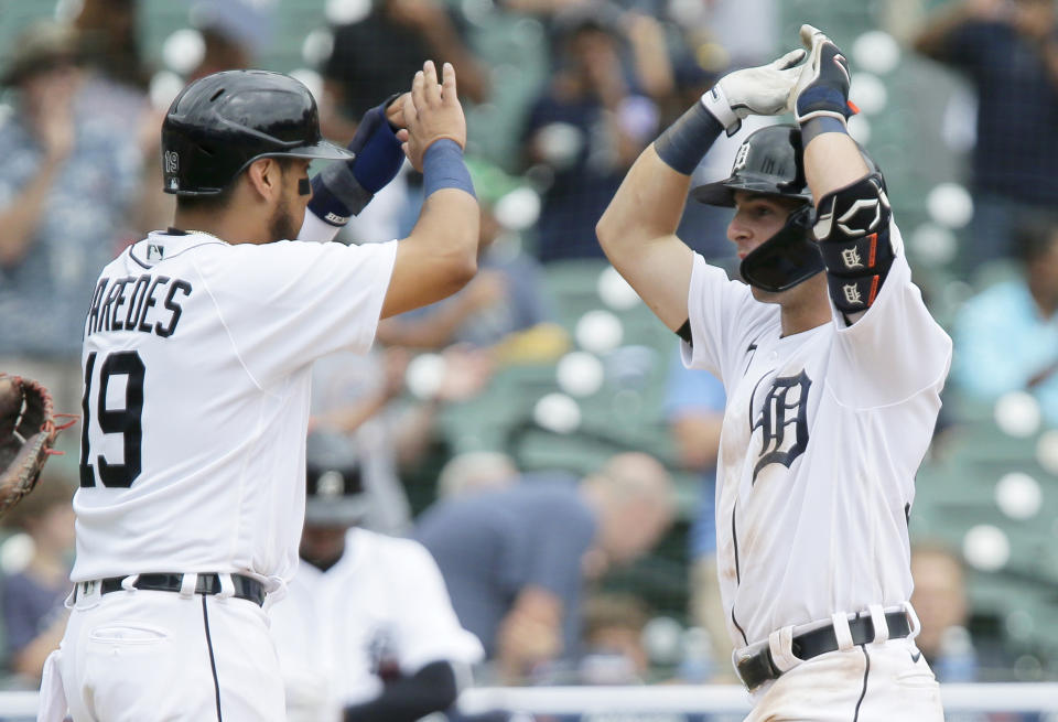 Detroit Tigers' Zack Short, right, celebrates with Isaac Paredes (19) after hitting two-run home run to break a 1-1 tie during the fifth inning of the first baseball game of a doubleheader Saturday, June 26, 2021, in Detroit. The Tigers defeated the Astros 3-1. (AP Photo/Duane Burleson)