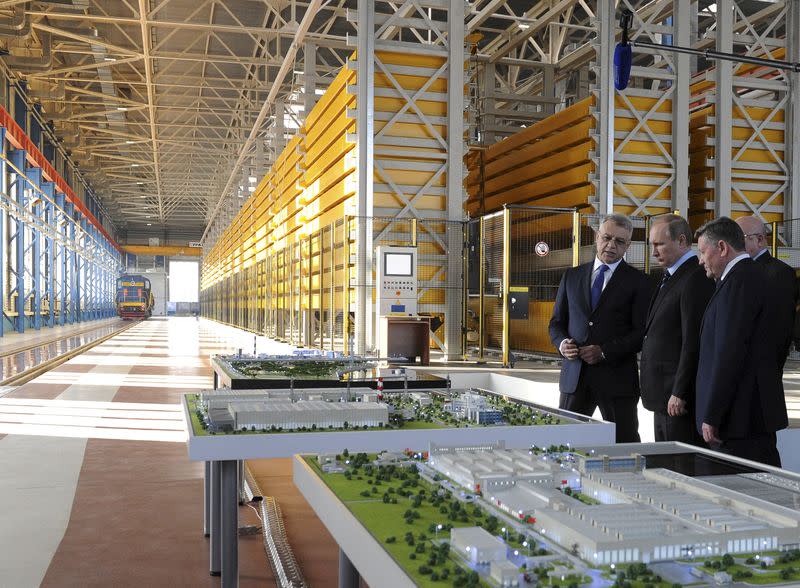 FILE PHOTO: Russian President Putin listens to Almaz-Antey CEO Novikov during visit to new 70th Victory Anniversary plant producing missile systems in Nizhny Novgorod