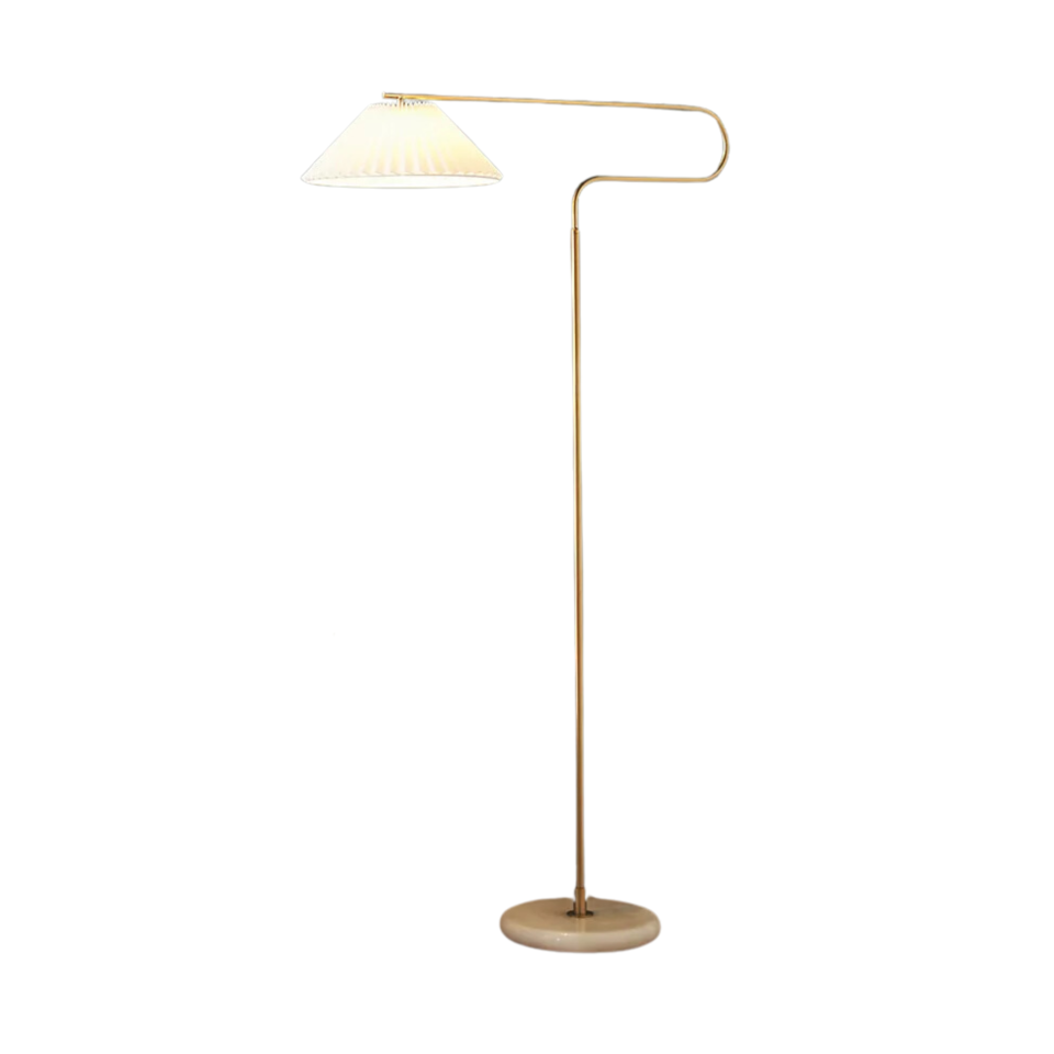A brass floor lamp with a pleated shade