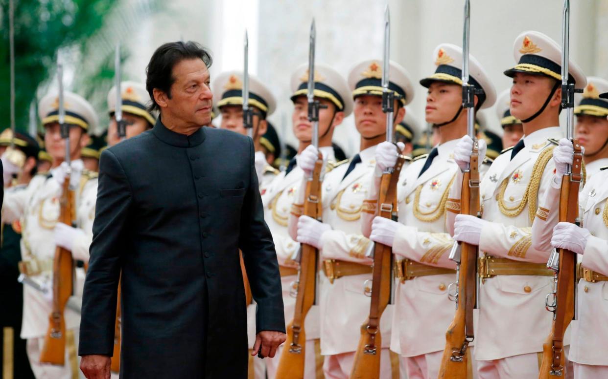 Pakistani prime minister Imran Khan attends a welcome ceremony in China - AFP