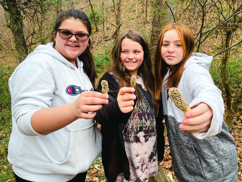 Emily Bressman, 14 years old, Layla Corvitt, who is almost 9, and 15-year-old Jayda Walsh hold up morels they found during Fungi Fest in Reeds Spring April 16, 2022.