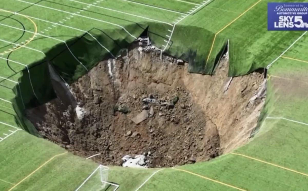 Huge sinkhole opens up under football pitch in Illinois