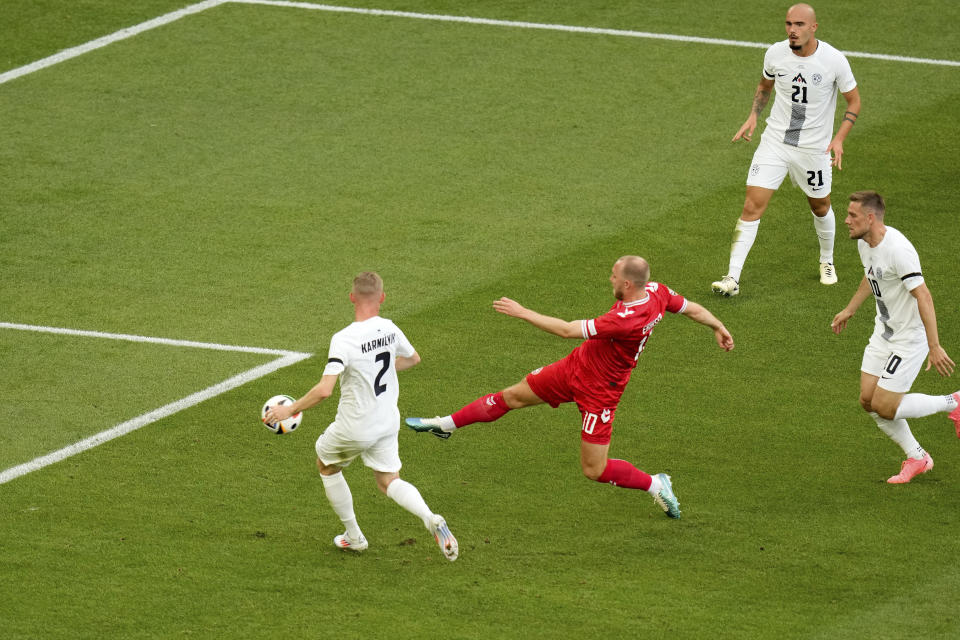 Denmark's Christian Eriksen, center, scores the opening goal during a Group C match between Slovenia and Denmark at the Euro 2024 soccer tournament in Stuttgart, Germany, Sunday, June 16, 2024. (AP Photo/Ariel Schalit)