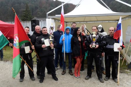 Winners poses for a family photo after a grave digging championship in Trencin, Slovakia, November 10, 2016, where eleven pairs of gravediggers are competing in digging based on accuracy, speed, and aesthetic quality. REUTERS/Radovan Stoklasa