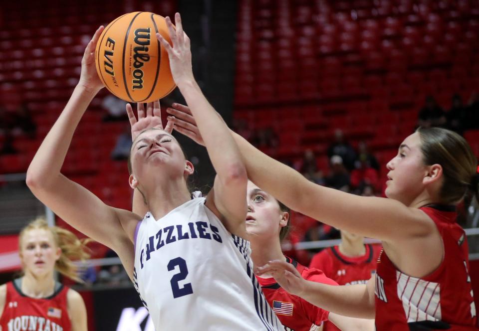 Copper Hills’ Ellie Taylor grabs the rebound as Mountain Ridge’s Kya Newton guards her during a 6A girls quarterfinal basketball game at the Huntsman Center in Salt Lake City on Monday, Feb. 26, 2024. Copper Hills won 49-31. | Kristin Murphy, Deseret News