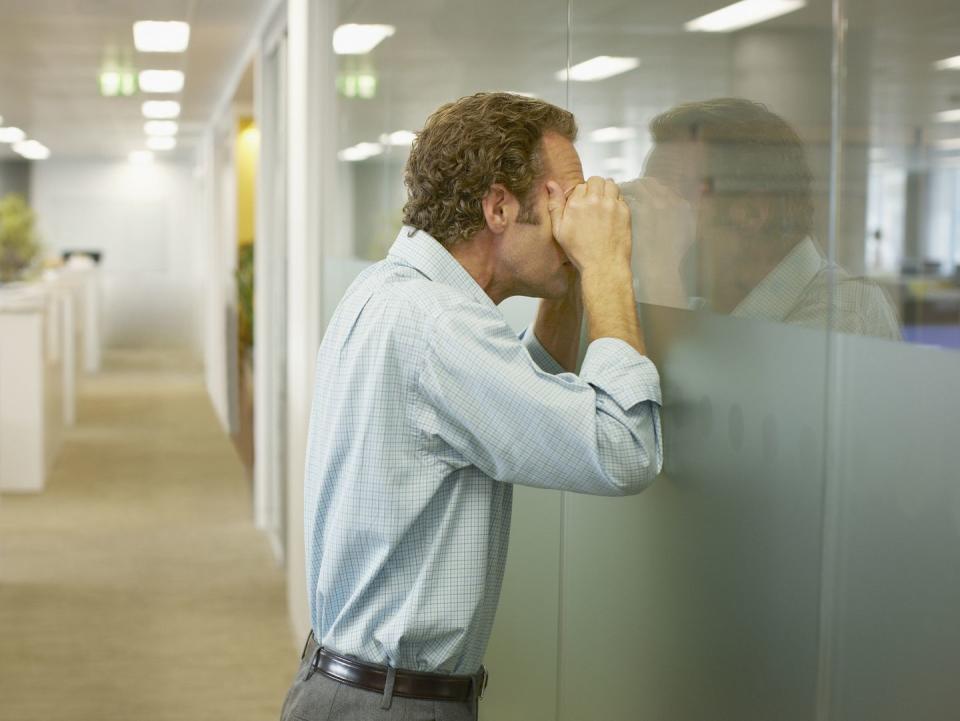 businessman peering into conference room