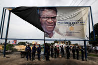 Congolese police officers stand under a banner for 2018 Nobel Peace Prize Denis Mukwege after a political rally of Martin Fayulu, the runner-up in Democratic Republic of Congo's presidential election in Kinshasa, Democratic Republic of Congo, January 11, 2019. REUTERS/Baz Ratner