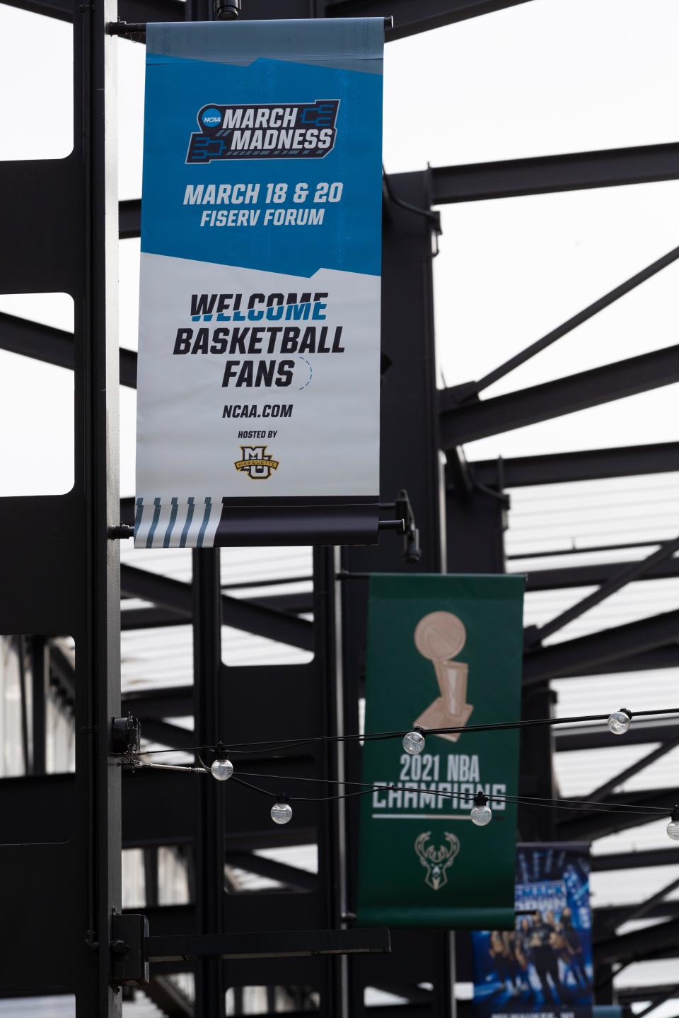 Signage for the NCAA men's basketball regional games are shown in the Deer District across from Fiserv Forum Monday, March 14, 2022 in Milwaukee, Wis.