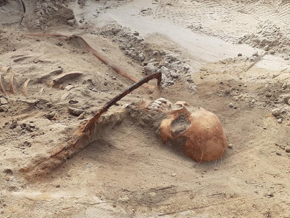 Female "vampire" with a sickle across her throat found in Pień, Poland.