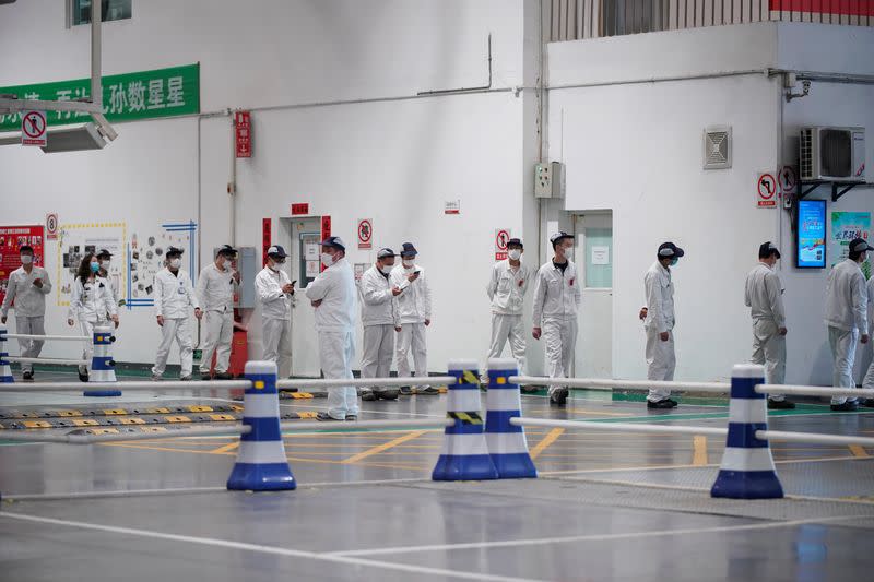 Employees line up inside a Dongfeng Honda factory in Wuhan