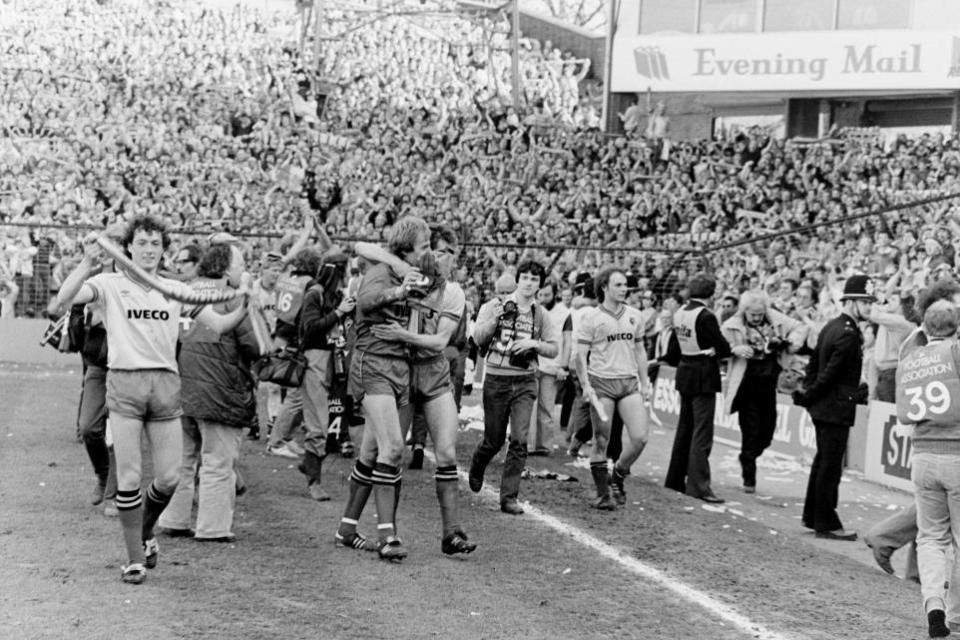 Watford Observer: David Bardsley with a scarf while Steve Sherwood is hugged