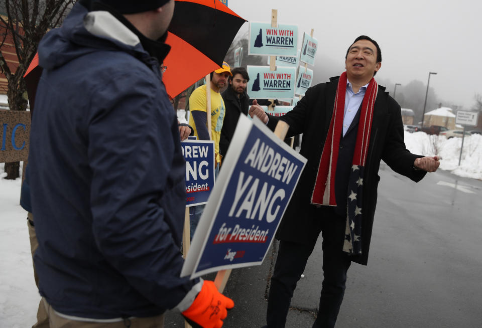 Democratic presidential candidate Andrew Yang greets supporters in who are holding signs in front of a polling station on February 11, 2020 in Keene, New Hampshire. New Hampshire holds its first in the nation primary today. (Photo by Justin Sullivan/Getty Images)