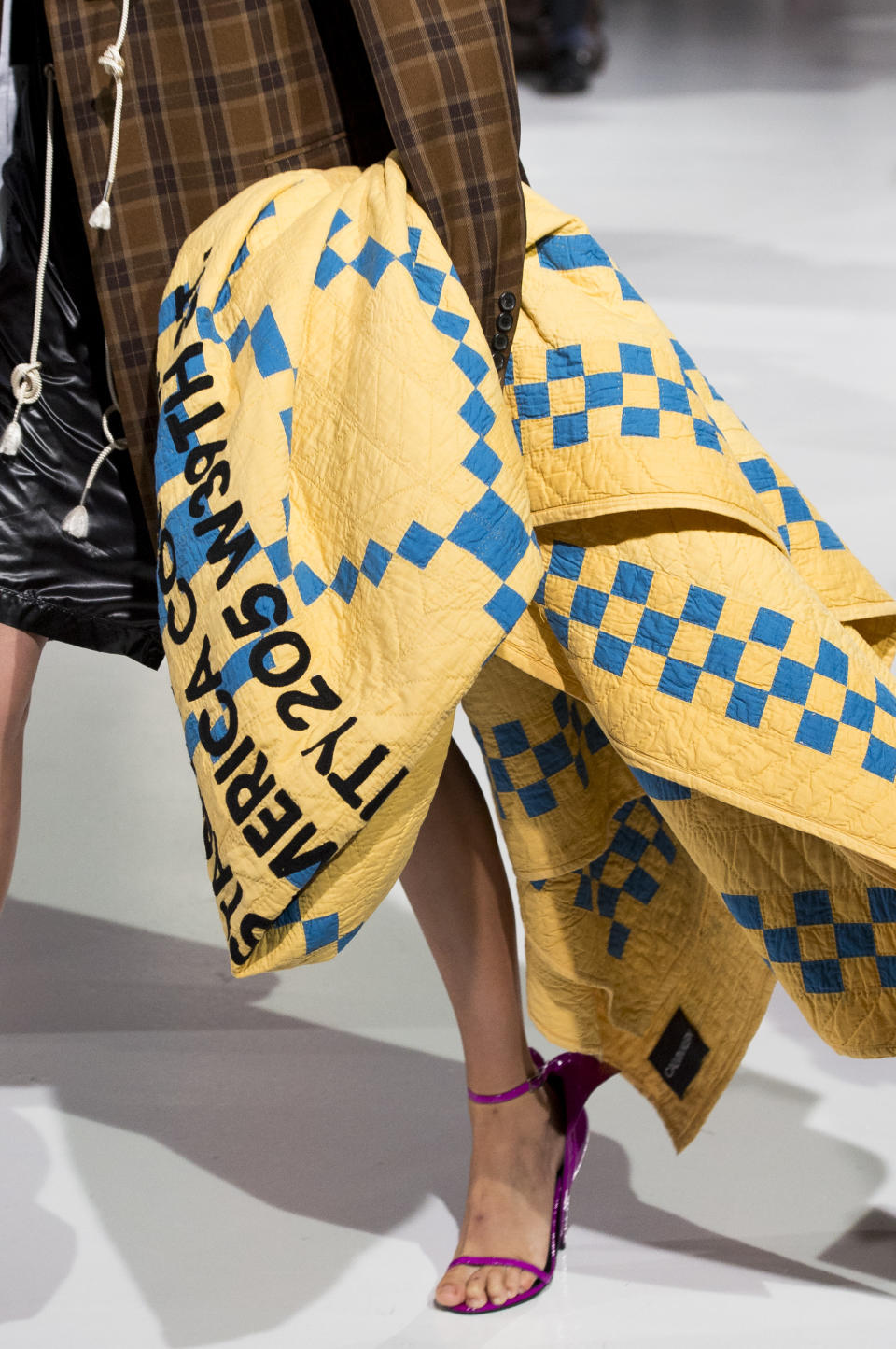 <p><i>Yellow and blue quilted blanket with Calvin Klein lettering from the SS18 Calvin Klein collection. (Photo: ImaxTree) </i></p>