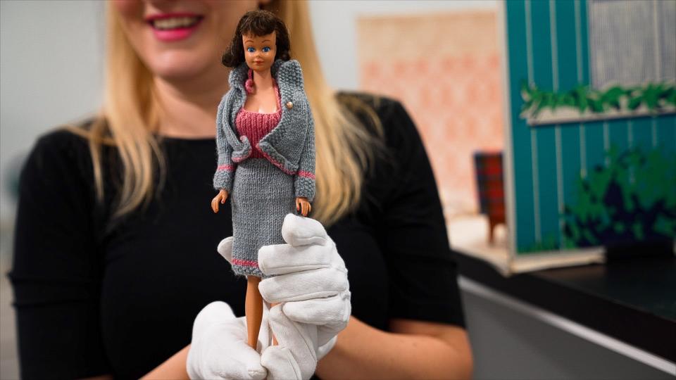 Lesley Struc displays a Midge doll, Barbie's best friend, wearing an intricate hand-knit skirt set made by a Fort Collins woman.