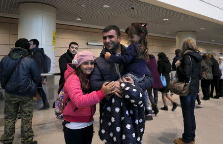 A man reacts after meeting his daughters, who are passengers of a flight from the Egyptian resort of Hurghada at Domodedovo Airport outside Moscow, Russia, November 7, 2015. REUTERS/Maxim Shemetov