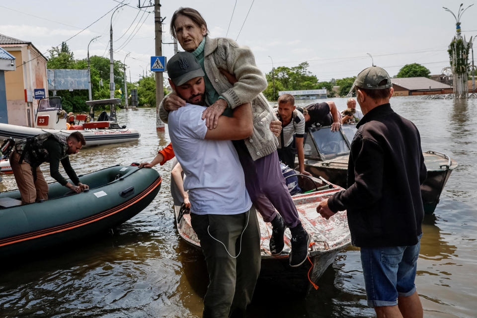 Volunteers help to evacuate residents from a flooded area after the Nova Kakhovka dam was destroyed amid Russia's ongoing invasion of Ukraine, in Kherson, southern Ukraine, June 8, 2023. / Credit: ALINA SMUTKO/REUTERS