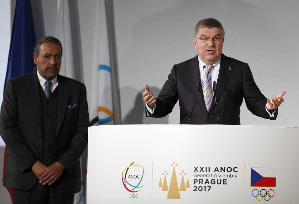 FILE - ANOC President Sheikh Ahmad al-Fahad al-Sabah of Kuwait, left, listens to IOC President Thomas Bach, right, addressing delegates during the general assembly of the Association of National Olympic Committees (ANOC) in Prague, Czech Republic, Thursday, Nov. 2, 2017. ong-time Olympic power broker Sheikh Ahmad of Kuwait has had his conviction for forgery upheld on appeal. However a court ruling in Geneva published Monday says the sheikh will not serve jail time for his part in a coup plot to implicate public rivals at home. (AP Photo/Petr David Josek, File)
