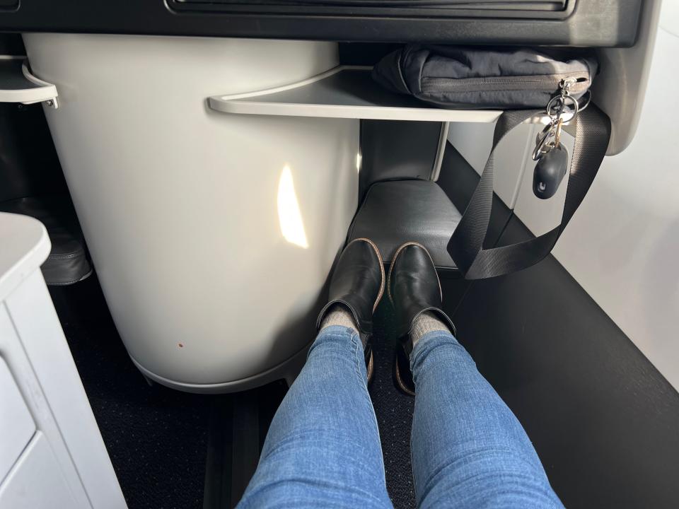 Flying on La Compagnie all-business class airline from Paris to New York — my legs stretched out.