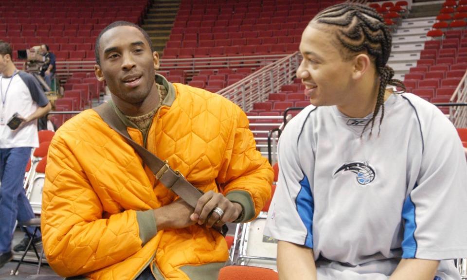 Kobe Bryant, left, and Tyronn Lue catch up after Lue had left the Lakers and eventually landed with the Magic.