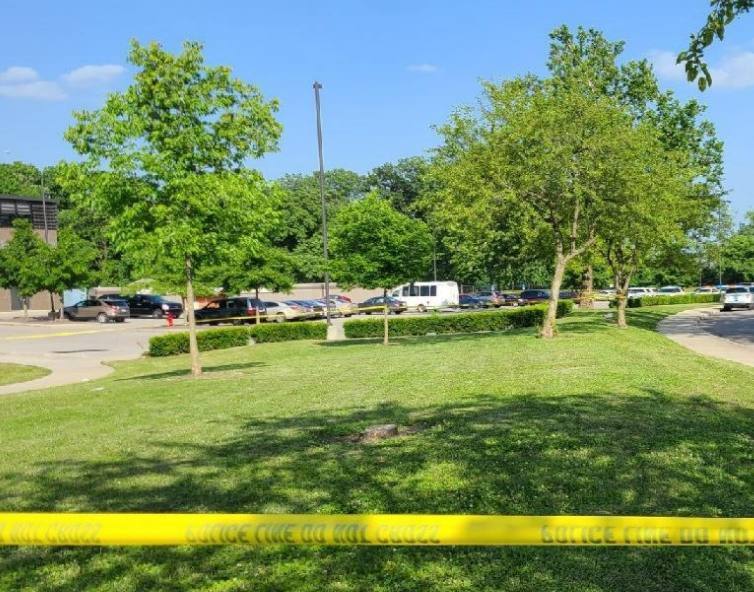 Crime scene tape cordons off a large area outside the Glenwood Community Center, at left, in Glenwood Park on the Hilltop following a shooting in which multiple people were shot.