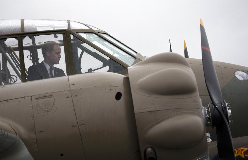 Britain's Prince William looks inside a vintage plane at the Omaka Aviation Heritage Center near Blenheim