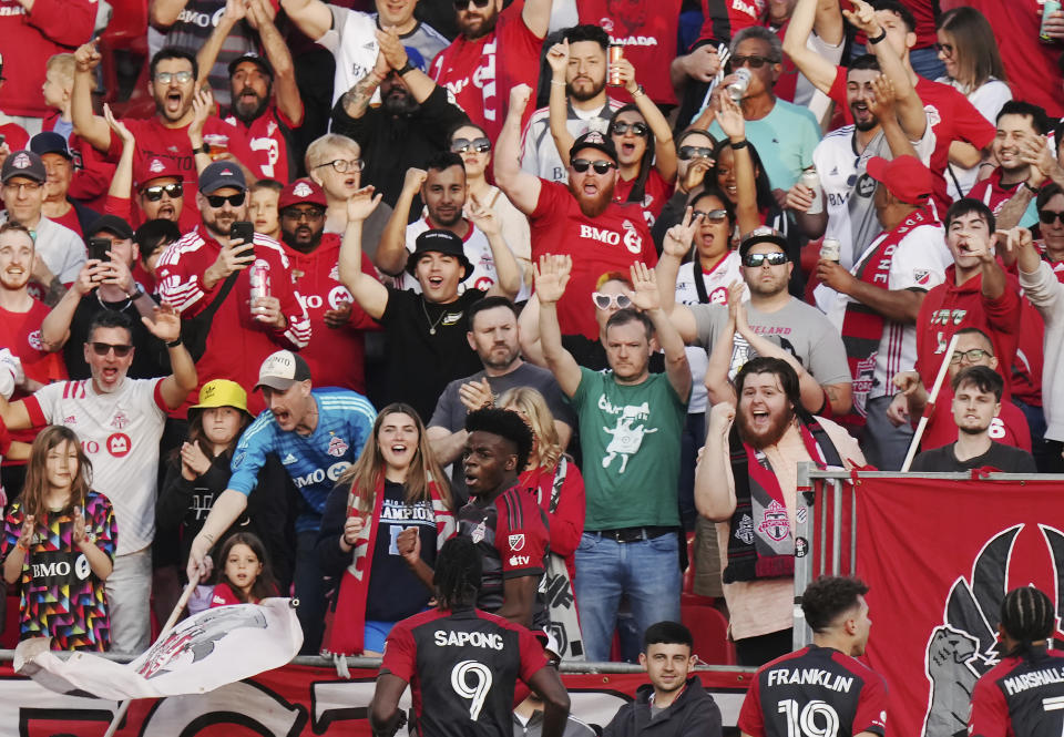 Toronto FC forward Deandre Kerr, center, celebrates his goal against D.C. United with fans and teammates during first-half MLS soccer match action in Toronto, Ontario, Saturday, May 27, 2023. (Chris Young/The Canadian Press via AP)