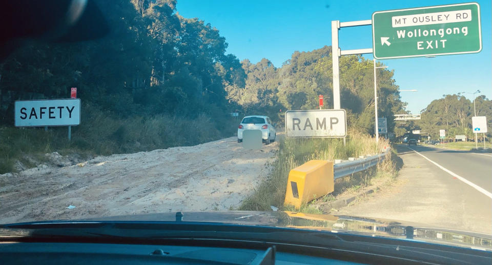 A white Mitsubishi Mirage pictured parked on a safety ramp at the bottom of Mount Ousley Road, Wollongong.