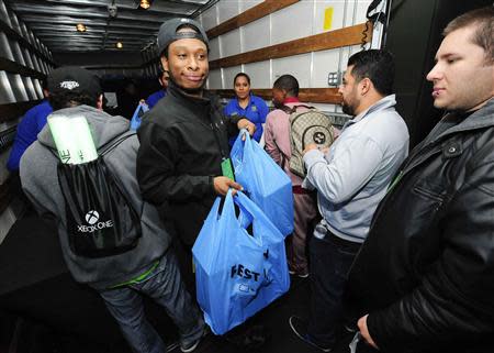 A Xbox fan leaves after being one of the first to receive their new Xbox One after midnight during the Xbox One fan celebration and launch party in Los Angeles, California November 22, 2013. REUTERS/Gus Ruelas