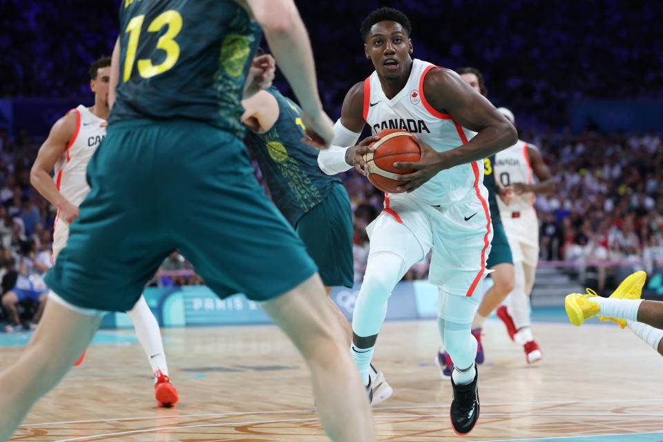 Canada's #09 Rj Barrett runs with the ball in the men's preliminary round group A basketball match between Canada and Australia during the Paris 2024 Olympic Games at the Pierre-Mauroy stadium in Villeneuve-d'Ascq, northern France, on July 30, 2024. (Photo by Thomas COEX / AFP) (Photo by THOMAS COEX/AFP via Getty Images)