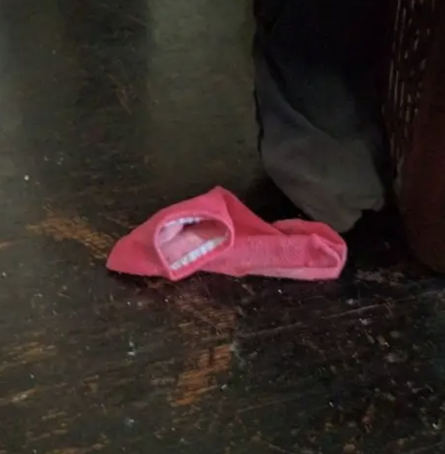 A red piece of clothing on a dark floor