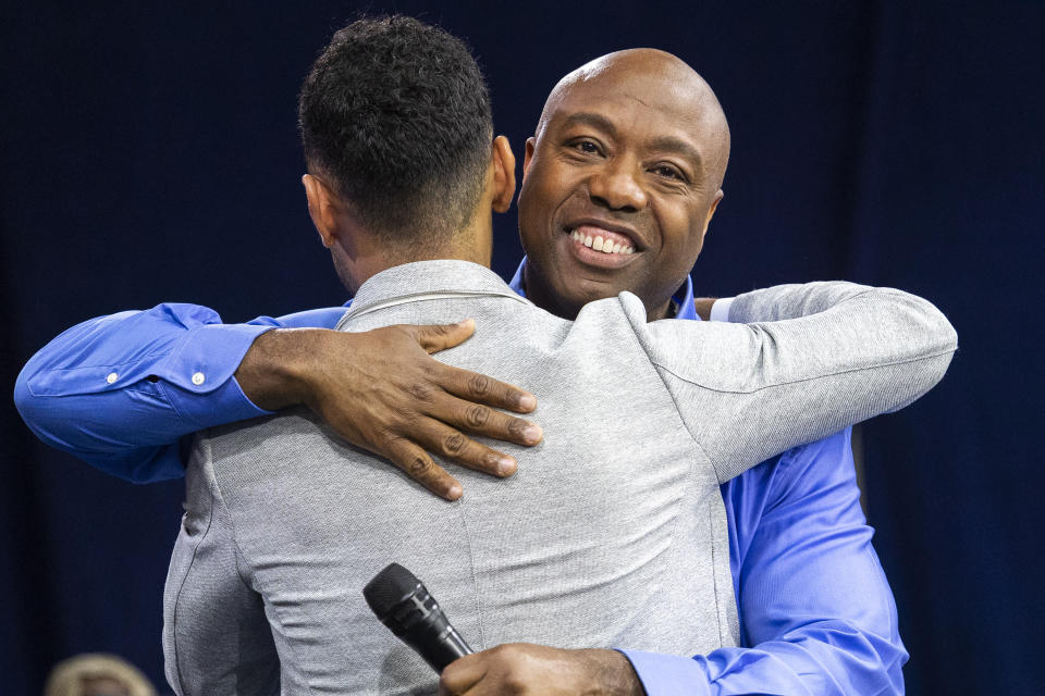 Republican presidential candidate Tim Scott hugs his nephew Ben Scott before announcing his candidacy for president of the United States on the campus of Charleston Southern University in North Charleston, S.C., Monday, May 22, 2023. (AP Photo/Mic Smith)