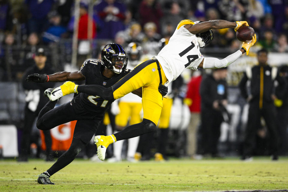 Pittsburgh Steelers wide receiver George Pickens (14) makes a catch in front of Baltimore Ravens cornerback Brandon Stephens (21) in the second half of an NFL football game in Baltimore, Fla., Sunday, Jan. 1, 2023. (AP Photo/Nick Wass)